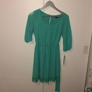 Green dress mid length sleeves flowy bottom